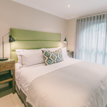 Tranquillity abounds in this slick guest bedroom where comfort is key and serenity comes standard.