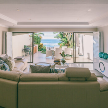 Lounge in comfort and superior style in this bright and breezy living room complete with top-class audio and video entertainment systems.